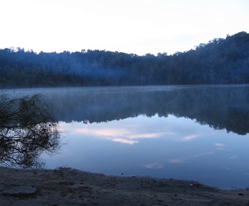 Mystical Destinations Image: The surrounding trees and sky are visible and reflected in the waters of the lagoon.