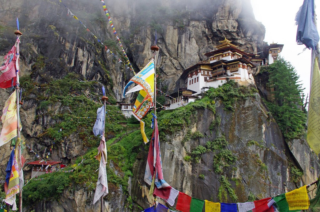 Destinations Worth Dreaming Image: Colourful flags and fabrics are suspended throughout as we see buildings leading up a mountainside.