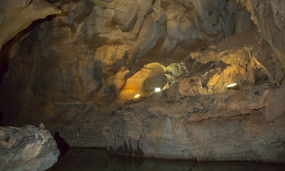 Cave Floating Image: A photograph showing a lightly lit rock wall caressed by ebbing water in Cuba's Indian Cave.
