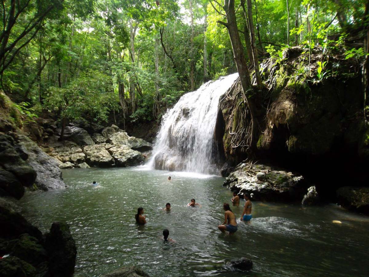 Hot Springs Image: Aguas Calientes Peru. People are enjoying soaking and swimming around in water as a small waterfall pours in.