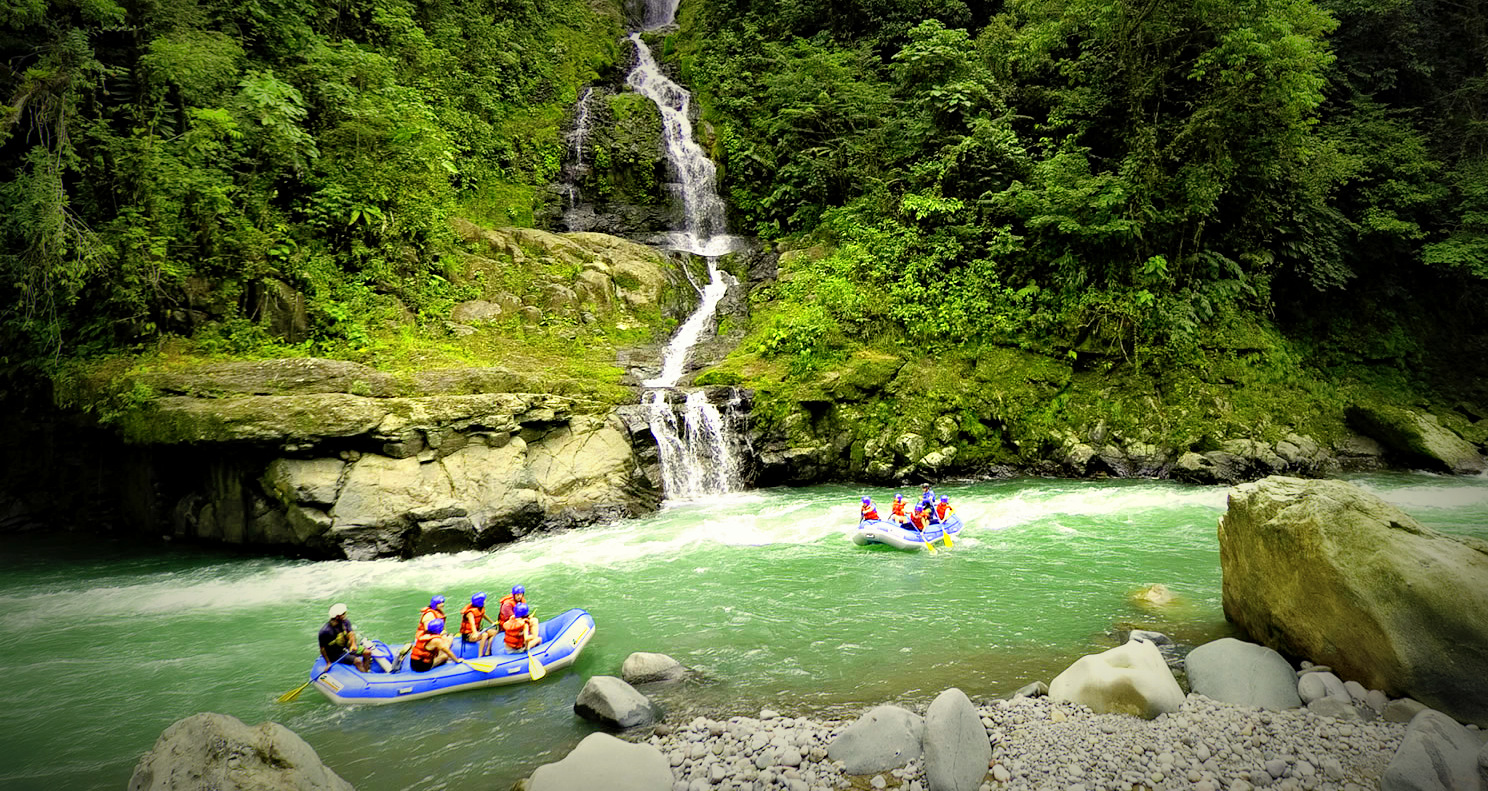 Costa Rica Rafting Image: Pacuare River. Two rafting boats full of adventurers are making their way down the Pacuare River.