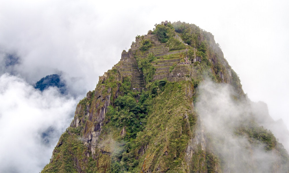Machu Picchu Travel Image: Machu Picchu emerges through the clouds of Peru.