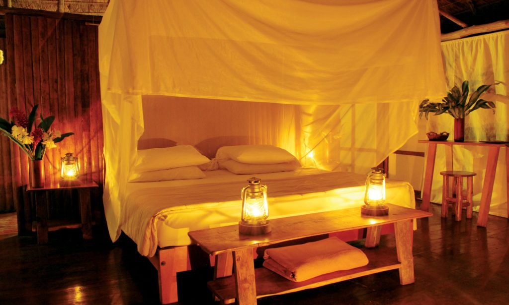 Peruvian Amazon Image: A suite boasts a large bed and glass lanterns.