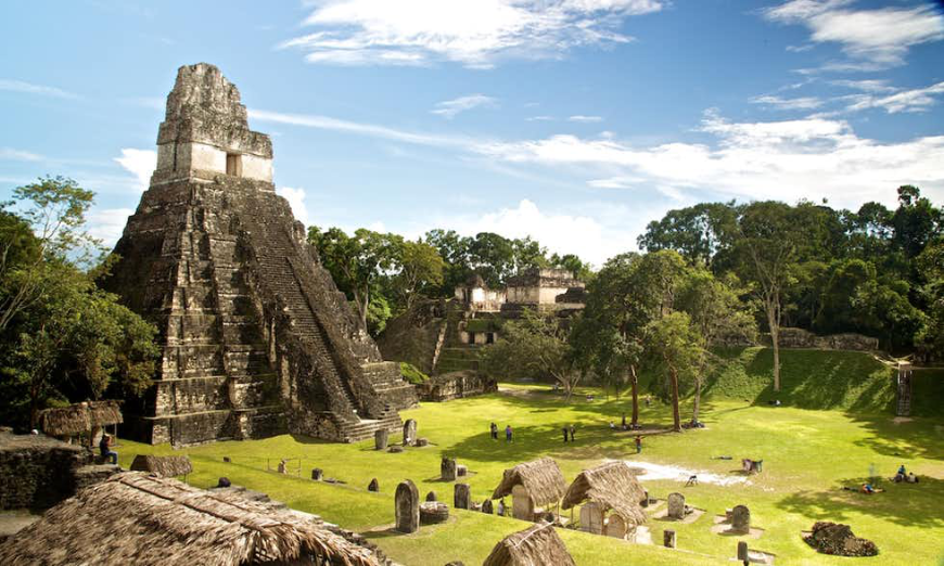 Belize and Guatemala Itinerary Image: The step pyramid Tikal looms over the Guatemalan jungle.