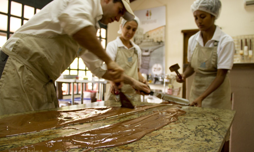 Best Chocolate Image: Three Sibú Chocolate makers pour and spread out their in-house chocolate.