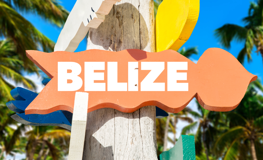 Best Islands in Belize for Everyone Image: Belize is written on a bright, wavy tangerine sign.