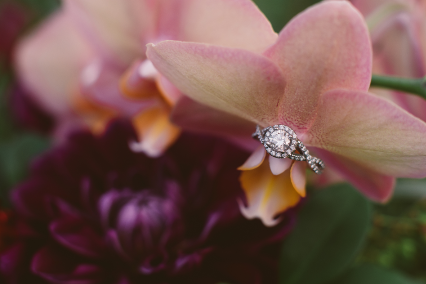 Best Proposal Ideas Image: A diamond engagement ring has been placed on an orchid.