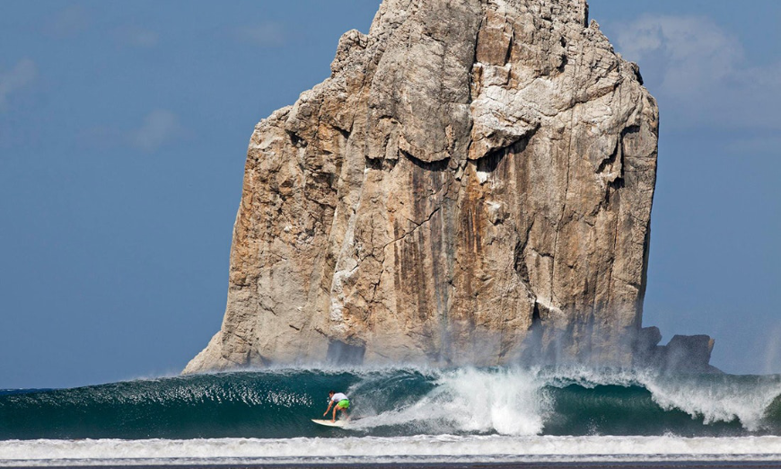 Costa Rica Activities Image: A surfer rides a cresting wave--some Costa Rica activities are epic, and not for beginners.