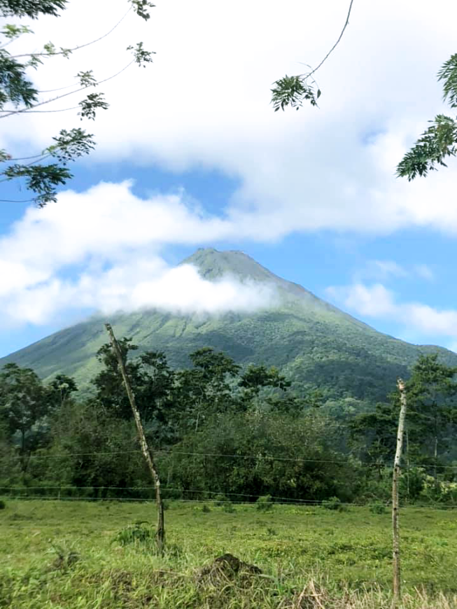 Costa Rica Couples Trip: Arenal Volcano with low clouds burning off.