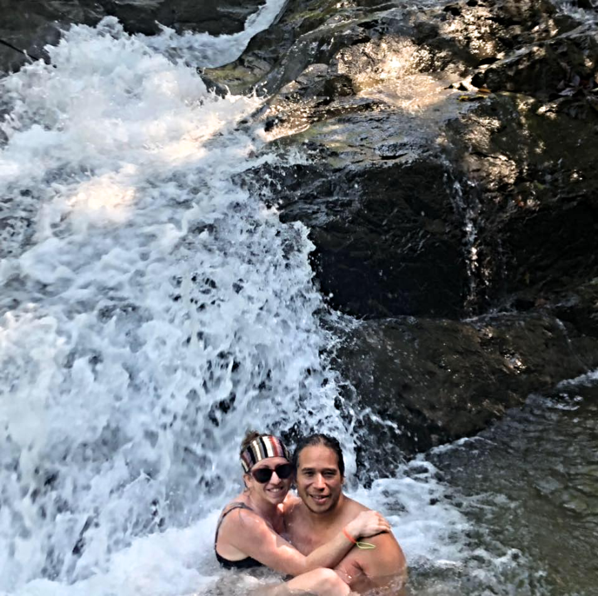 Costa Rica Couples Trip: The Pearson/Lepine's smile and embrace as water cascades around them.