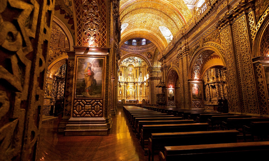 Destination Wedding in Ecuador Image: Warm wooden pews, artwork, and the golden interior of La Compañía de Jesús cathedral. 