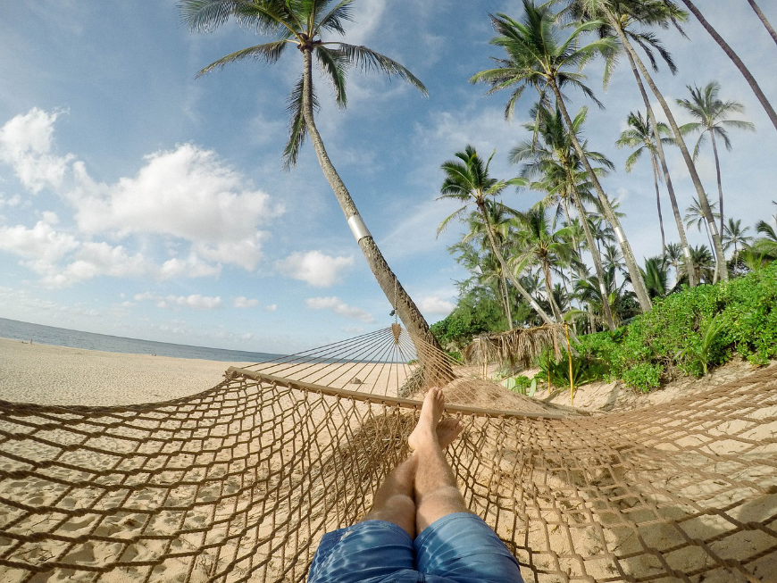 Diving In Belize Image: Point of view, a man's legs are extended in the hammock he lay in.