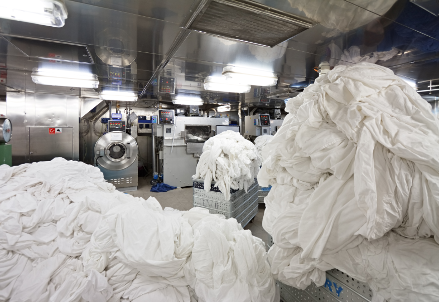 Eco-Friendly Destination Wedding Image: Oversized loads of laundry wait in a hotel's laundry facilities.