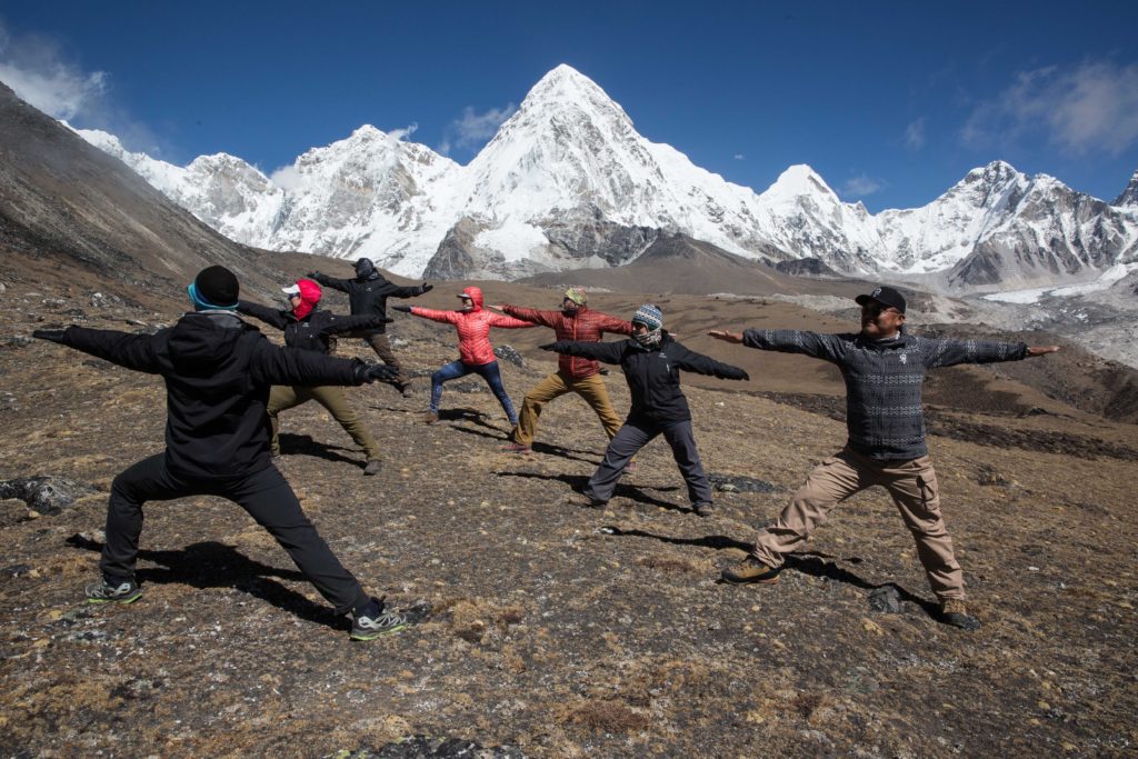 Everest Trek Image: Six members of the Everest Base Camp trek are pictured doing the Warrior pose as they follow the moves of their yoga instructor.