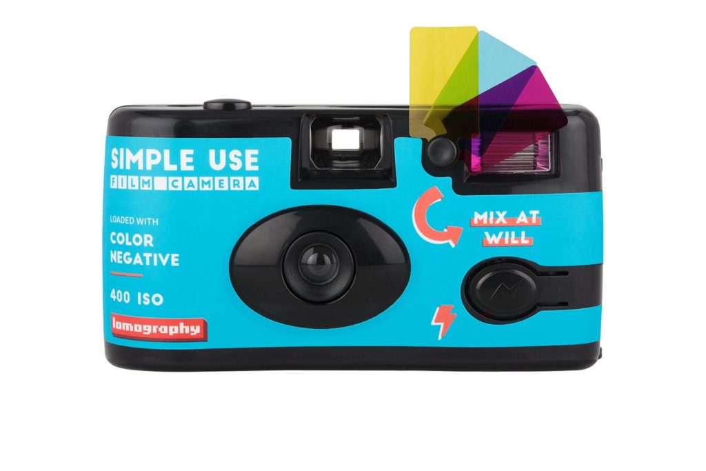 Family Adventure Image: A "Simple Use" disposable camera from lomography.com in teal, with three color gel flash filters in magenta, yellow, and cyan.