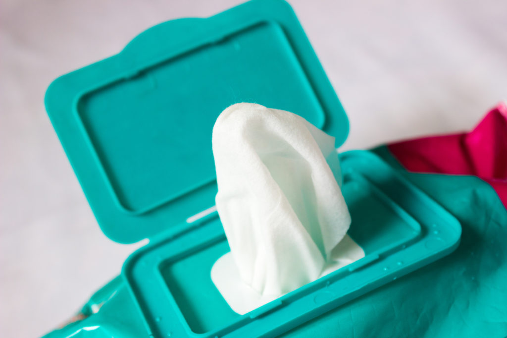 Family Adventure Image: A wet wipe is popping out of a turquoise container.
