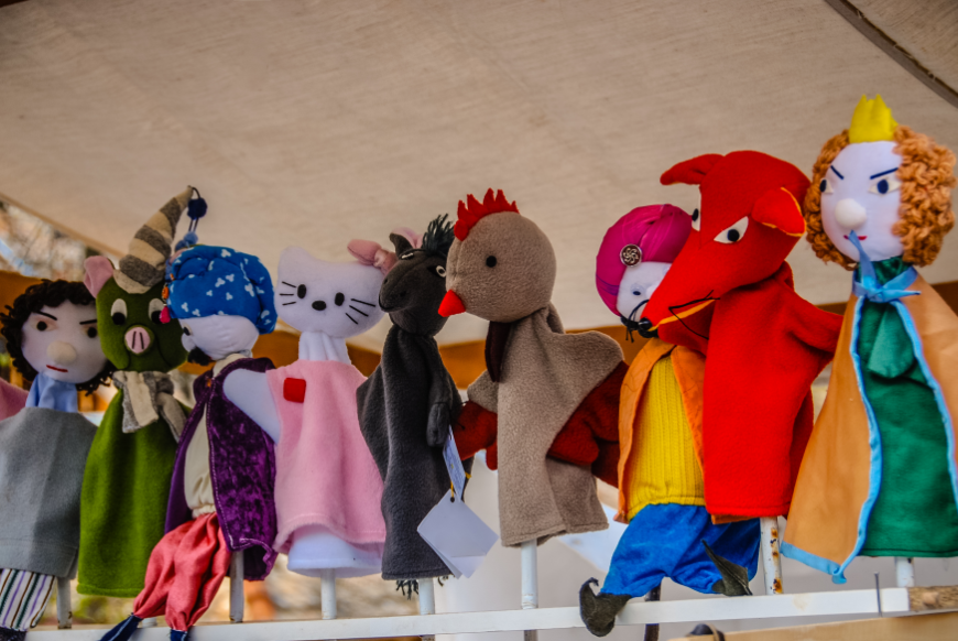 Imagination Bus Image: Animal and people hand puppets are lined up waiting for their next performance.