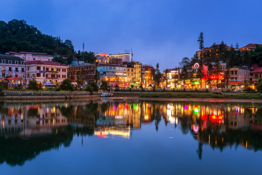 Is Sapa Worth Visiting Image: City lights surround the edge of the lake and are reflected in its waters.