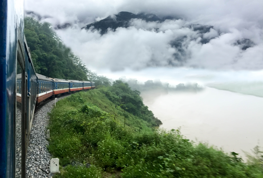 Is Sapa Worth Visiting Image: A train travels through greenery and mist.