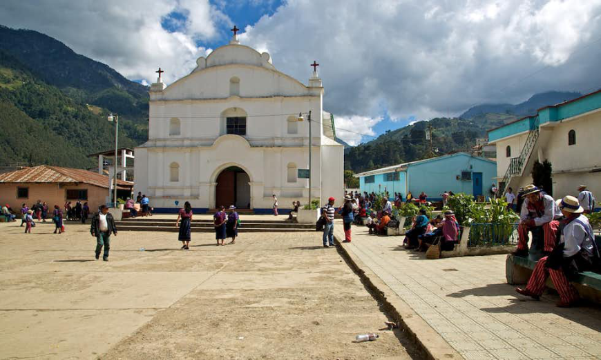 Mayans of Guatemala Image: Locals are scattered before a white church.