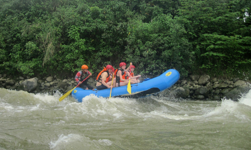 Moving to Panama Image: A group of people are partially lifted up over big rapids.