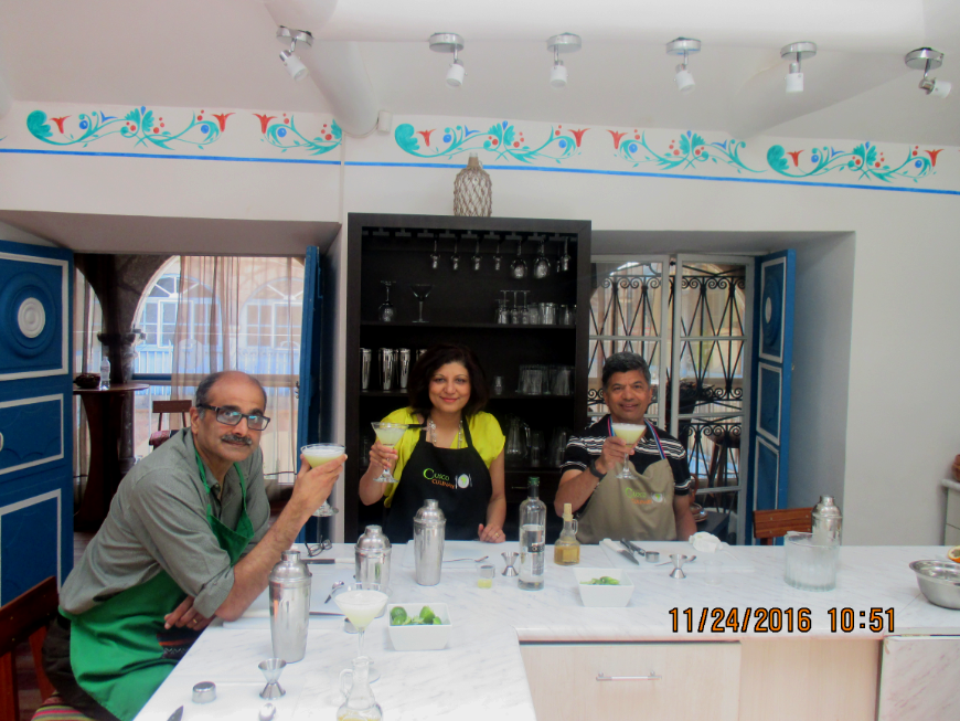 Peru Group Tour Image: Three members of the party are seen holding up glasses of the pisco sours they learned how to make.