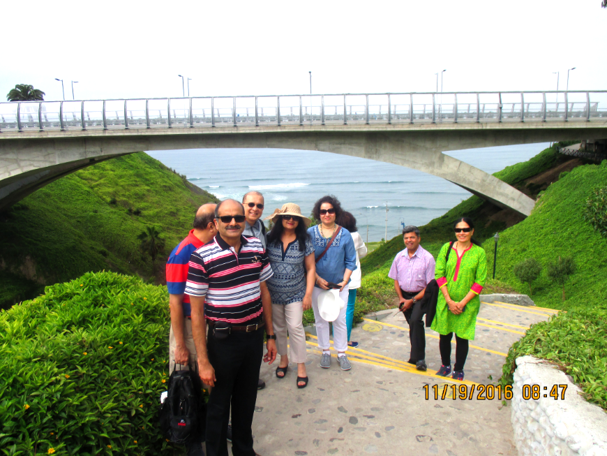 Peru Group Tour Image: A group photo in front of an ocean view.