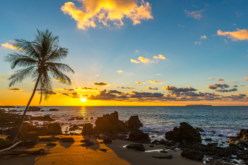Is It Safe to Travel in Costa Rica Image: The sun sets on a picturesque beach.