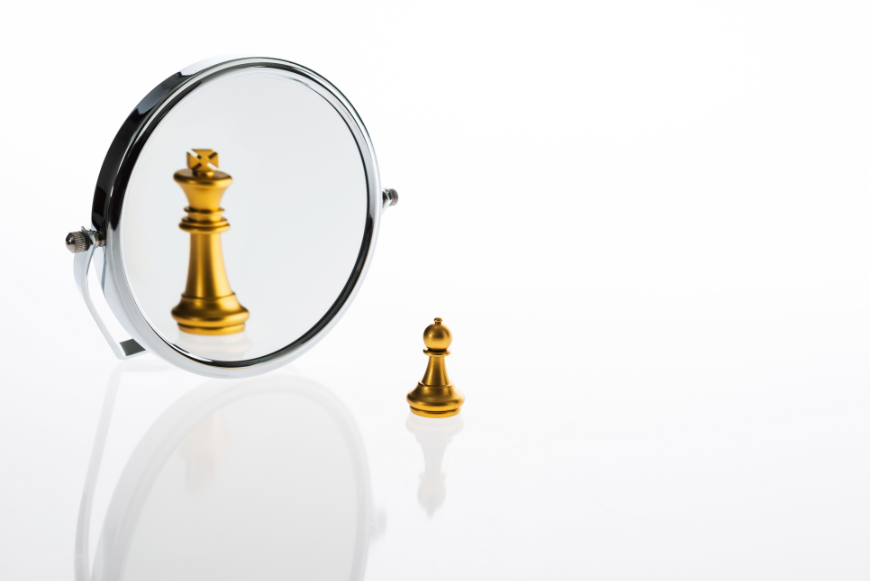 Sustainable Tourism Entrepreneurs Image: A gold pawn chess piece looks in a mirror and sees a king.