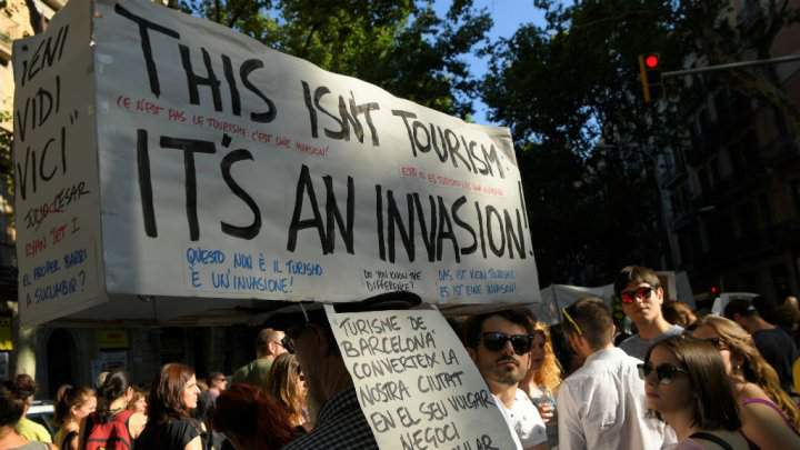 Sustainable Travel Image: Barcelona protestors take to the streets with signs decrying over-tourism.