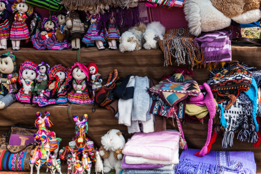 Peru Souvenir Image: A variety of stuffed dolls sit on the shelves of a Peruvian market. These little dolls make excellent (and soft) Peruvian souvenirs.