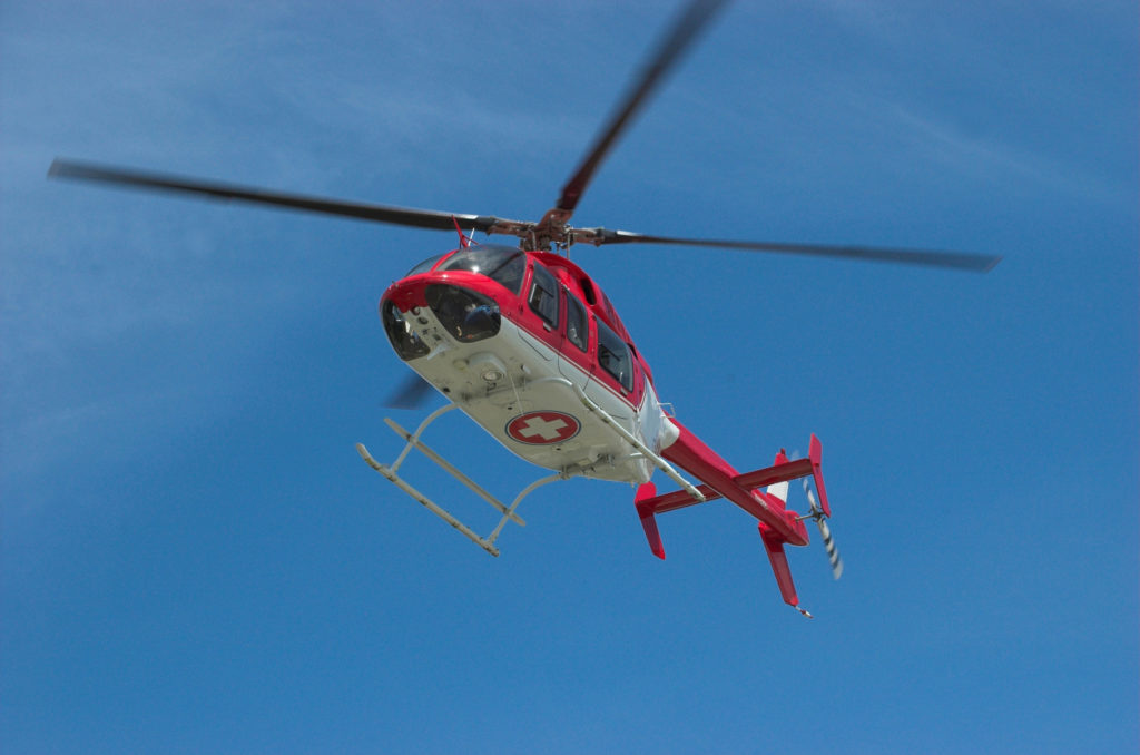 Why Travel Insurance Is A Must Image: Medical helicopter taking off.
